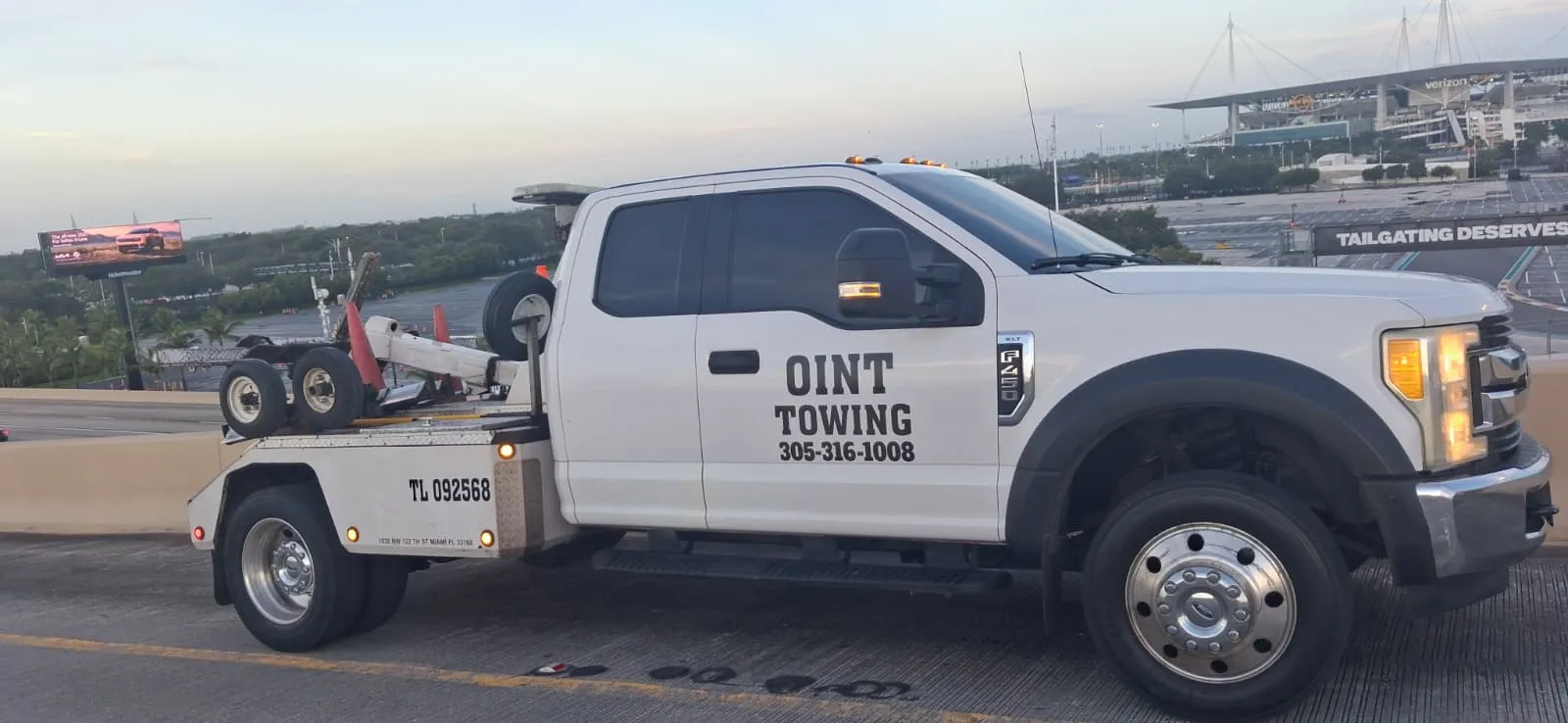 Oint Towing INC truck at dusk